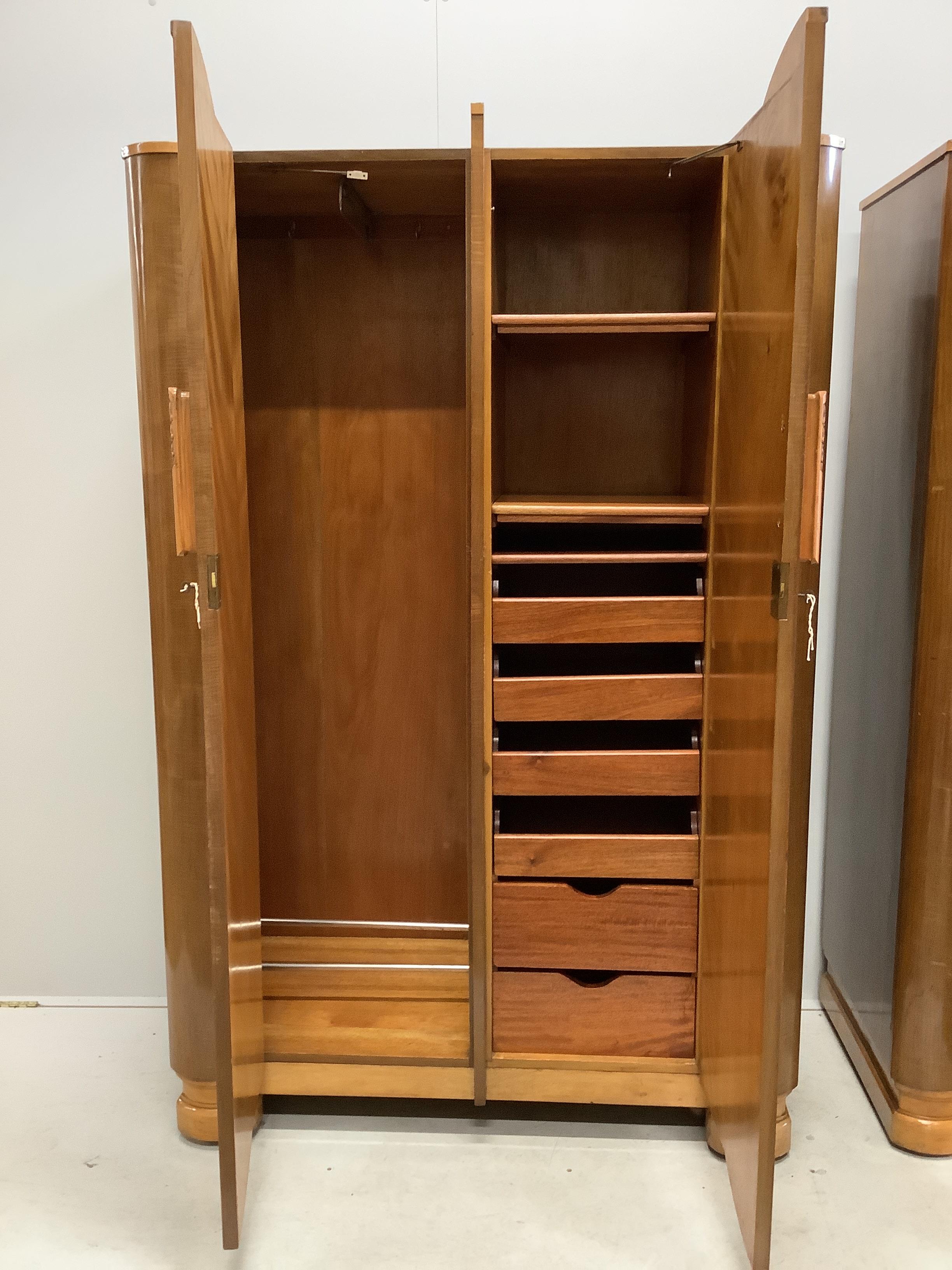 A pair of Art Deco walnut compactum wardrobes, width 116cm, depth 54cm, height 183cm